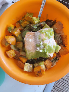 A quinoa bowl with sweet potatoes and salmon