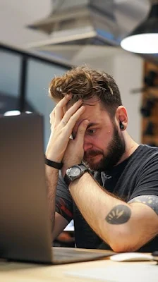 Man sitting at his desk disguised