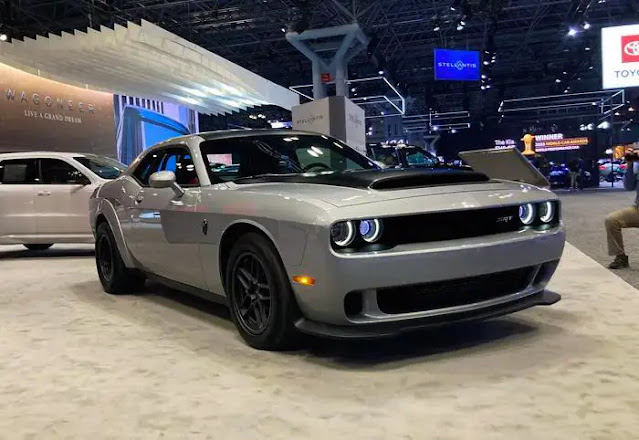 A silver Dodge Challenger SRT Demon 170 is seen from the front, with other cars in the background.