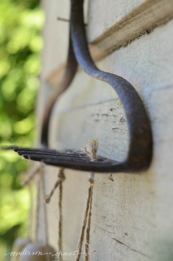 Garden Tool Organizer made from a repurposed metal rake head....a convienent and decorative way to store tools |  www.andersonandgrant.com