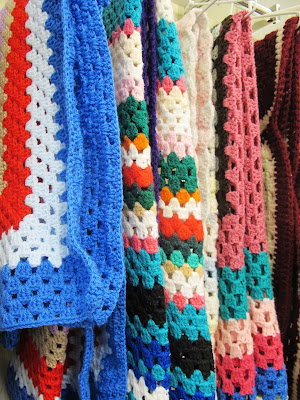 Selection of crocheted afghan rugs at Vinnies' Queanbeyan op shop.