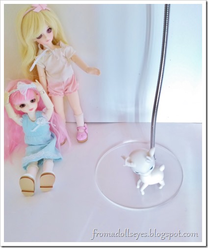 The tiny deer is trying to use the doll stand, but it's too small.  It looks sad.