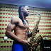  Shirtless Flavour pictured playing a Saxophone... 