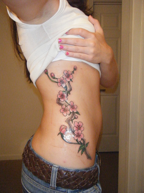 cherry blossom branch tattoo. cherry blossom tattoo - hips