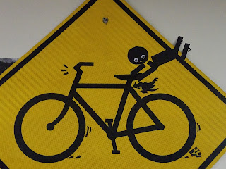 bicycle safety yield sign decorated with a person flying off