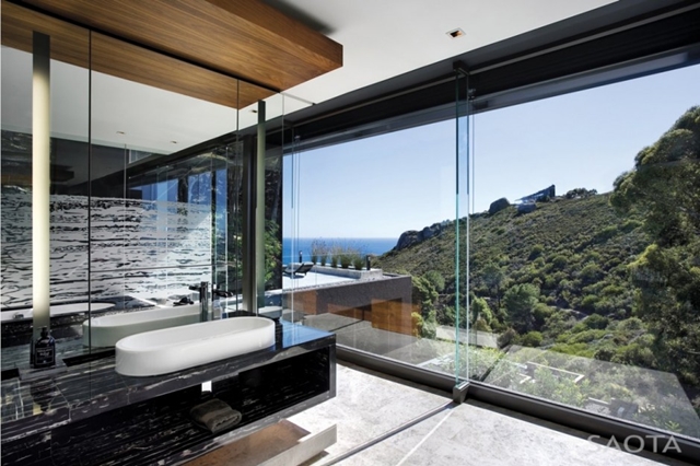 Picture of modern minimalist bathroom with the ocean and mountains view through the glass wall