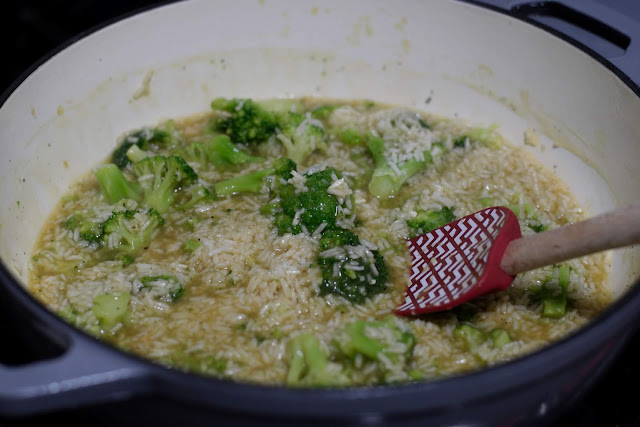 The rice and broccoli mixture being stirred into the broth.  