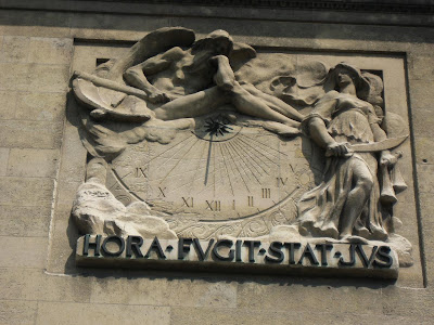 Interesting sundial on the side of an old Paris building