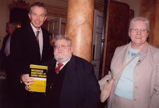 t blair, john and alice, the pm holding john's book