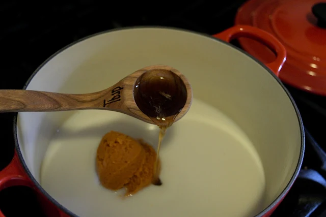 Maple syrup being added to the pot. 