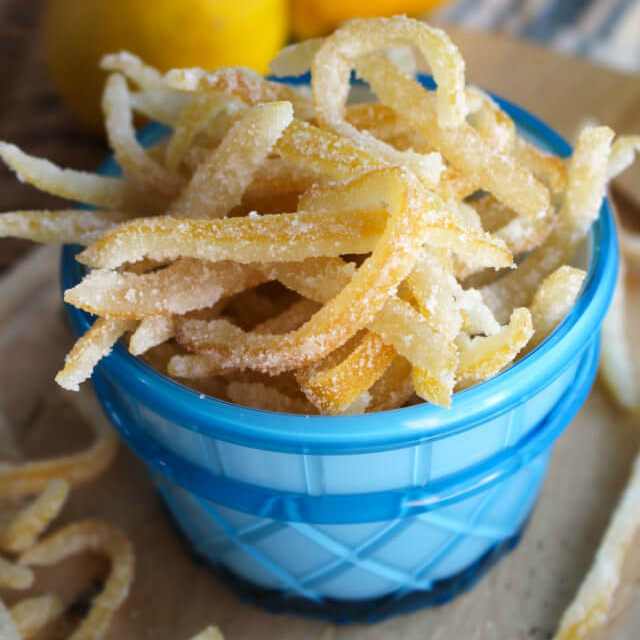 Candied Lemon Peel in a blue cup with a brown background.