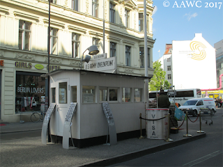 A small hut-like structure sits in the middle of the road, a replica of what was there during the Cold War.