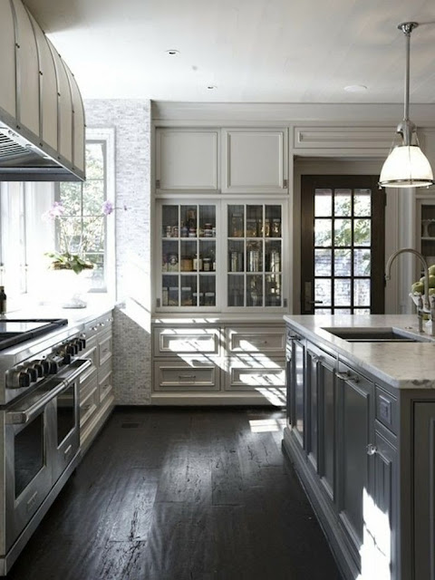 beautiful traditional black and white kitchen with white marble counter island light taupe gray painted panelled cabinets with glass