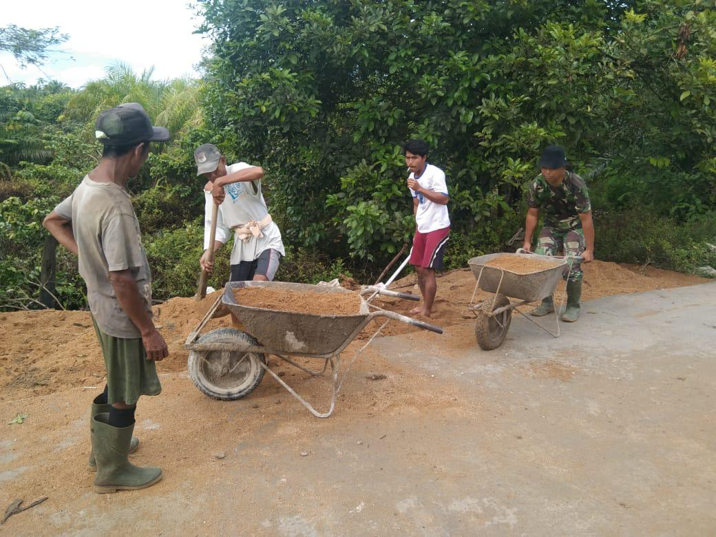 Antusias warga bantu anggota satgas TMMD pindahkan pasir sisa Pembangunan jalan