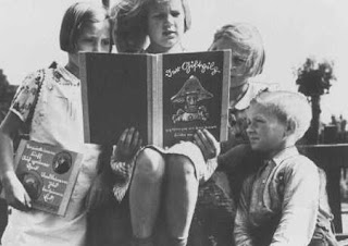 The photo of the german children reading The Poisonous Mushroom (The Toadstool) published by Julius Streicher, prominent Nazi