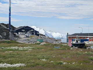 a neighborhood view in Ilulissat, Greenland - icebergs just along the shore