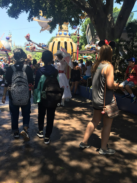 Mary Poppins Character Passing Astro Orbiter In Disneyland