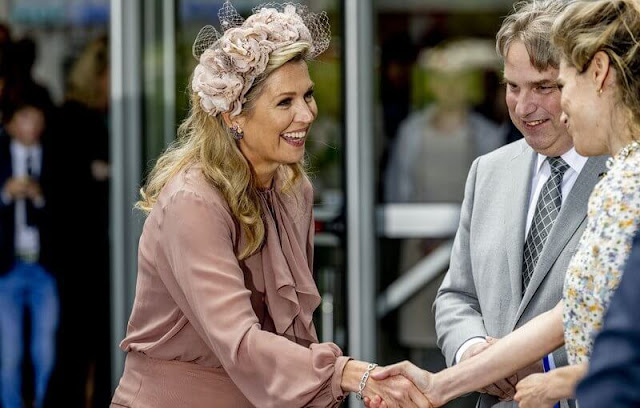 Queen Maxima wore a new asymmetric flounce skirt and top by Natan. Berry Rutjes hat and headpiece designer