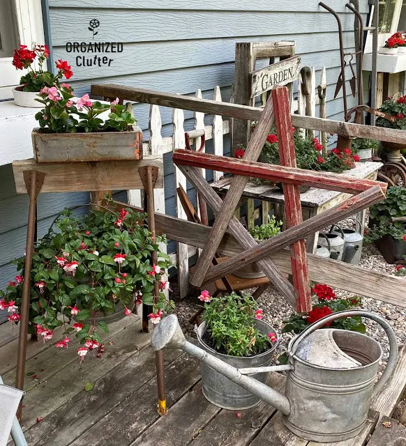 Photo of junk garden vignettes on the corner of the deck