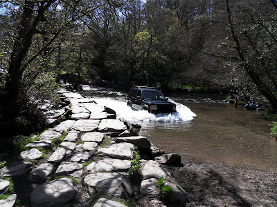 car driving through the river by Tarr Steps