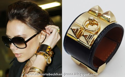 Victoria Beckham accessorized her gray and black ensemble with gold jewelry Victoria Beckham accessorized her gray and black ensemble with gold jewelry