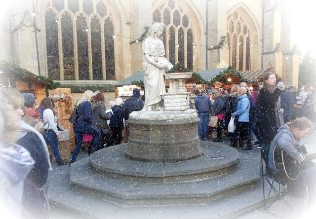 Bath Christmas Market, featuring large statue and digitally added snow