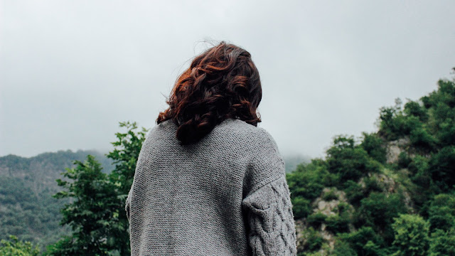 woman wearing cardigan, rear view Photo by Teymur Gahramanov on Unsplash