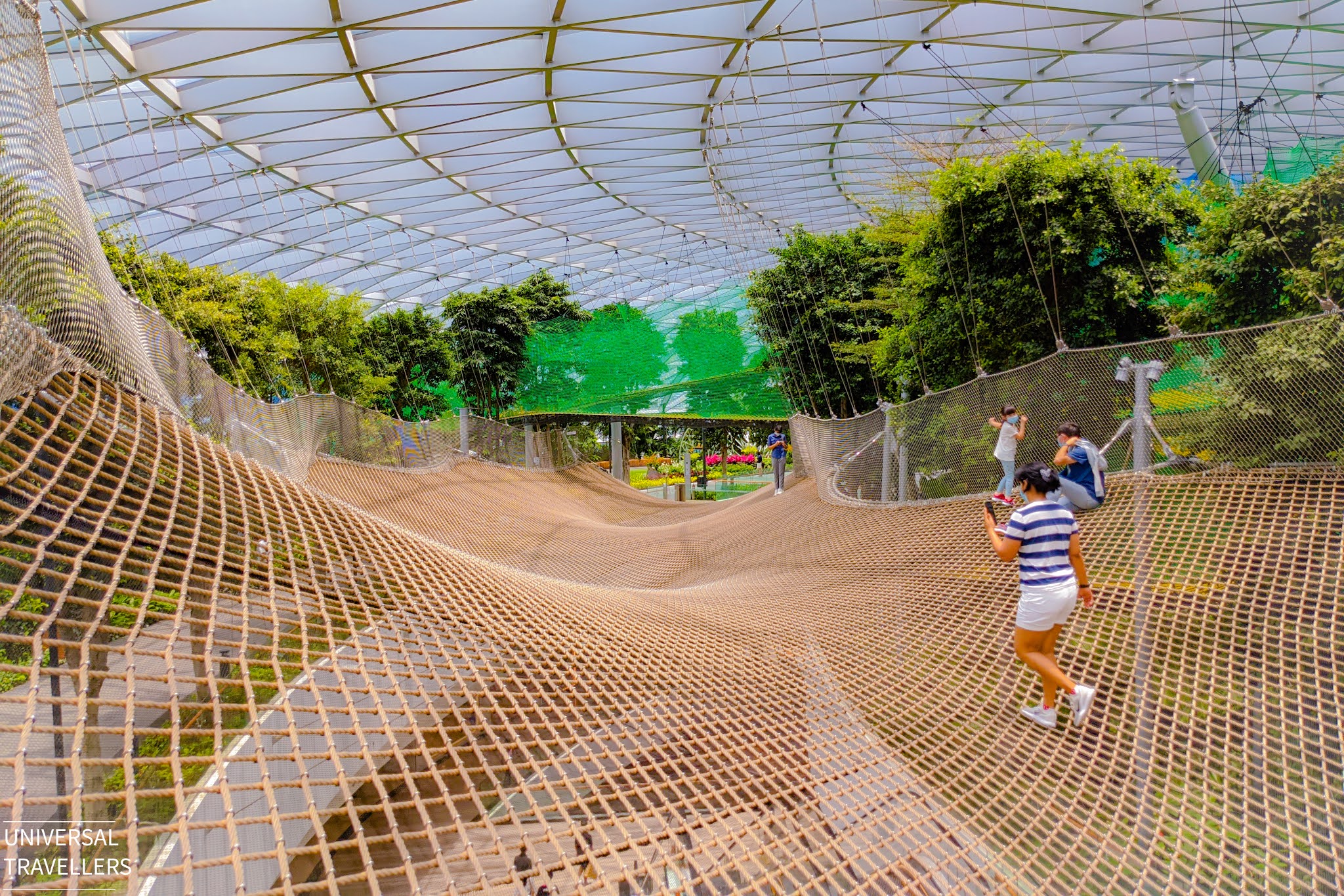 A girl is walking on the Manulife Walking Sky Net, located at level 5 inside the Jewel Changi Airport