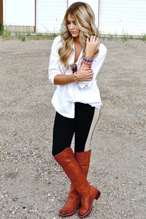 Woman wearing black leggings and brown riding boots