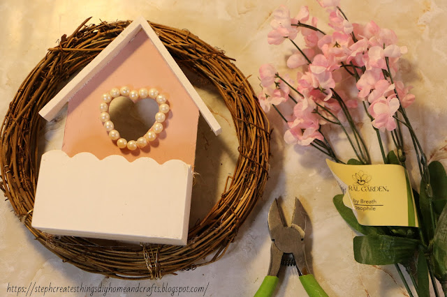 heart box on wreath near faux floral and floral cutters