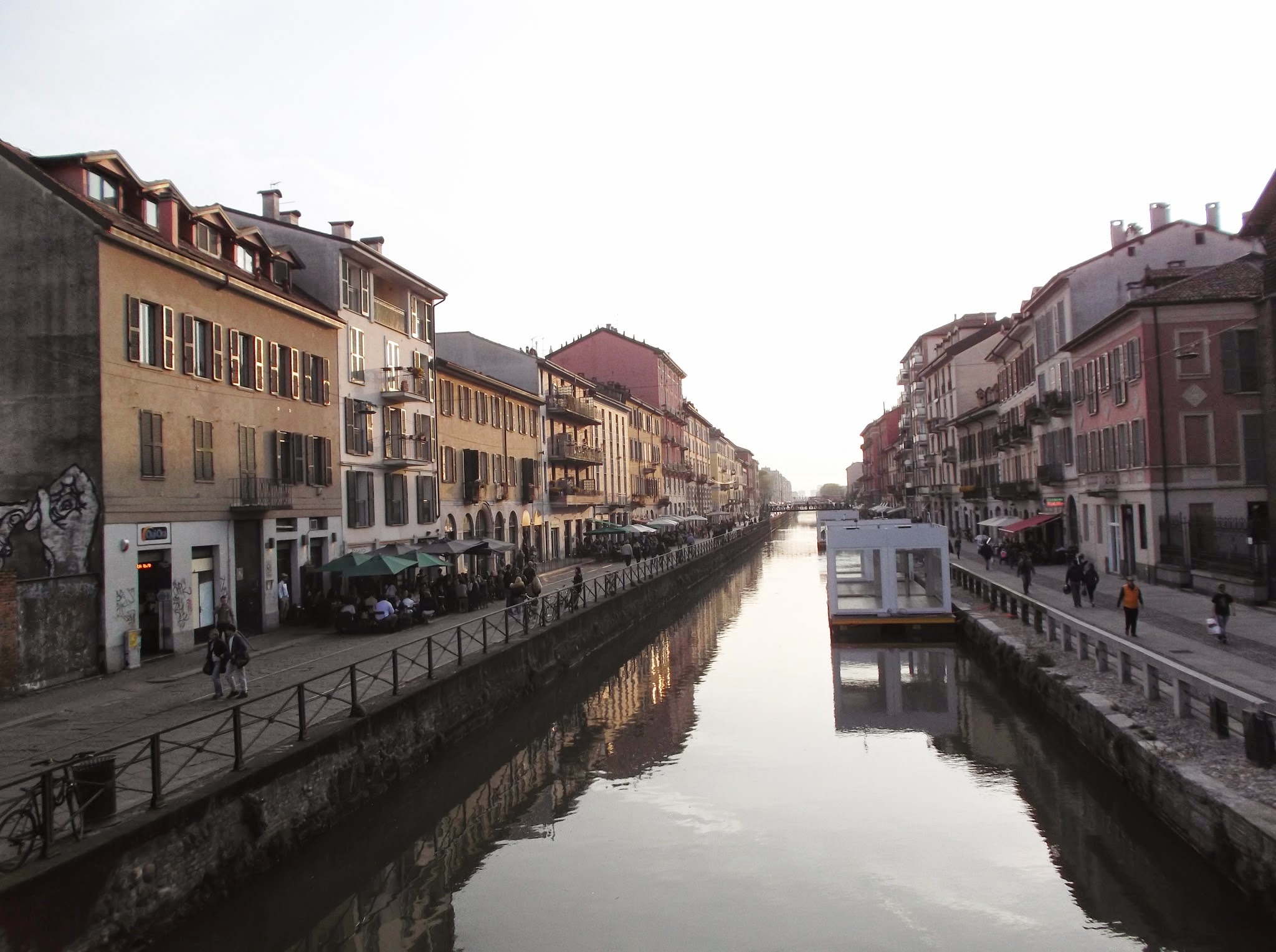 people walking alongside a canal