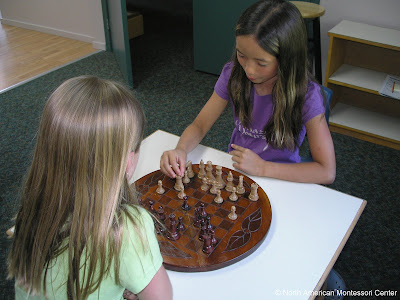 Promoting Parent Involvement NAMC montessori classroom community students play chess