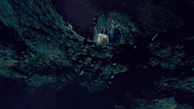 two people gazing into a hole
