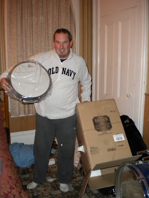 John with a huge grin, holding one of his new drums