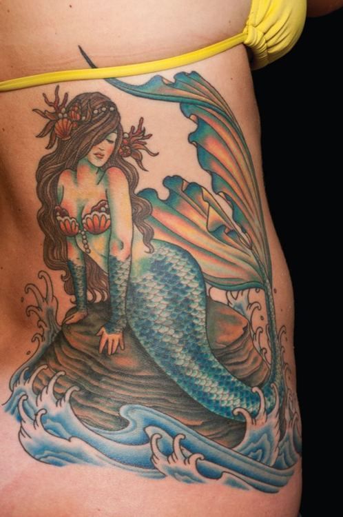 colourful-mermaid-on-the-rock-ribs-side-tattoo