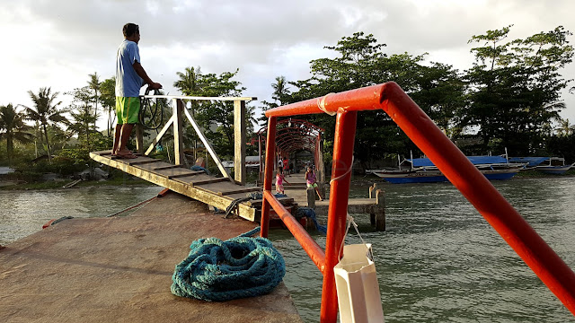 commuter boat pushing back on a trip to Tacloban at the wharf of San Antonio, Basey Samar