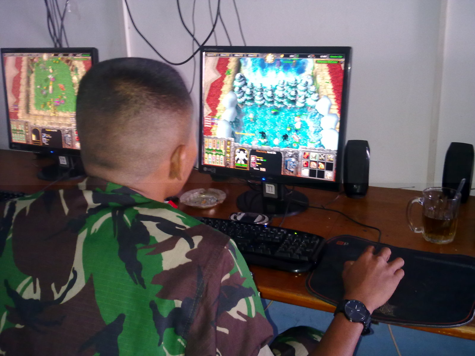 Seorang TNI Bermain Game Warcraft di  Warnet  unikgaul