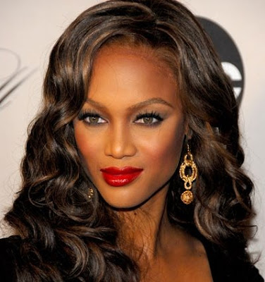 Tyra Banks with sophisticated multi-layered bun updos.