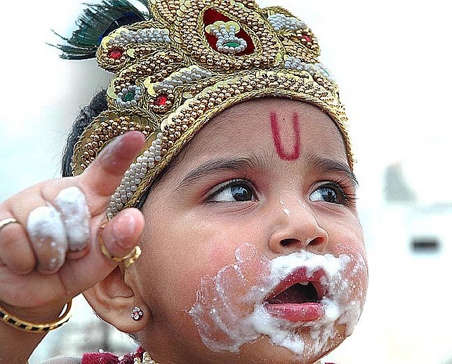 WORLD WITH MY EYES: A child dressed as Lord Krishna, pose on the