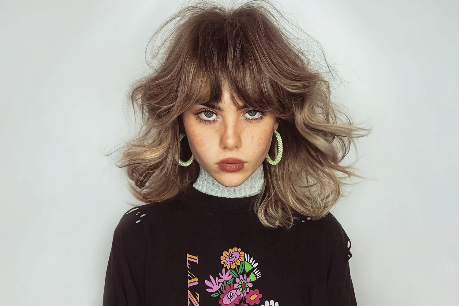 a portrait of woman with voluminous wavy hair