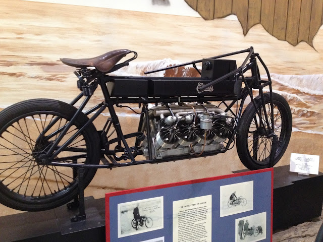 https://en.wikipedia.org/wiki/File:Glenn_Curtiss_on_his_V-8_motorcycle,_Ormond_Beach,_Florida_1907.jpg