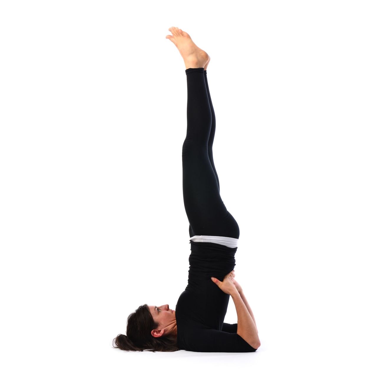 Slim woman doing Salamba Sarvangasana pose on yoga mat - a Royalty Free  Stock Photo from Photocase