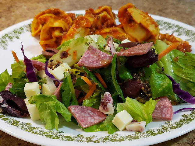 Antipasto salad with tortellini pasta with spaghetti sauce