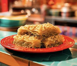 Baklava dessert from morocco on a red plate in a colorful kitchen