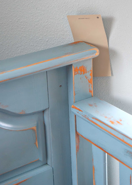 Close up of crib makeover with distressed finish