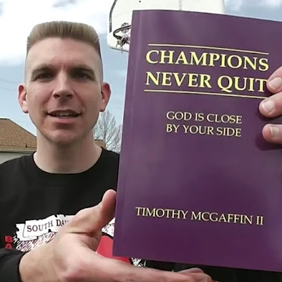 Tim McGaffin holding "Champions Never Quit: God Is Close By Your Side" close up