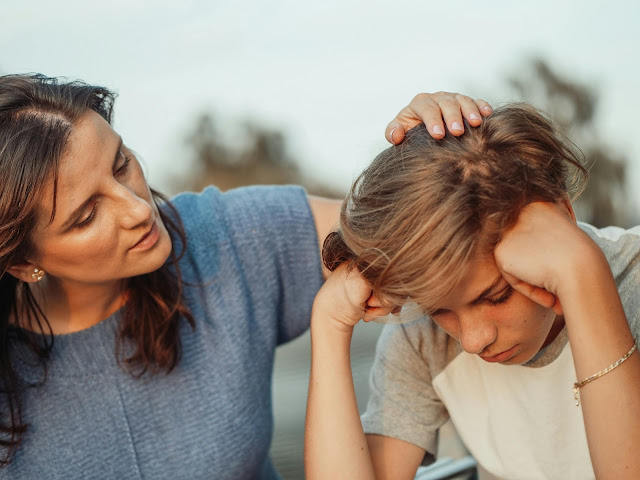 woman-in-blue-shirt-talking-to-a-young-man-in-white-shirt