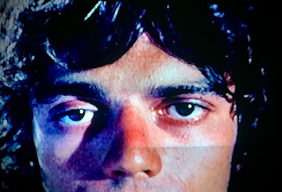 Close up of a man’s face as he stares blankly forward in a scene from deadly blows.