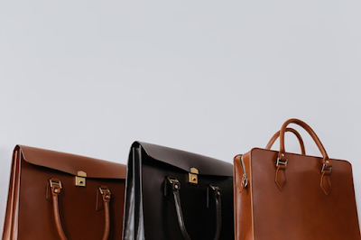 Three Brown and Black Leather Bags of Different Sizes