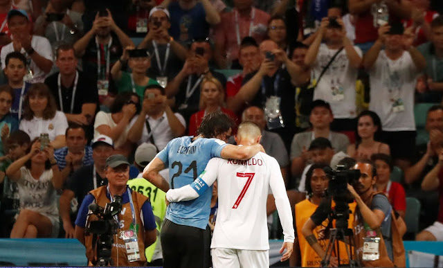 Cristiano Ronaldo helps injured cavani off the pitch during uruguay vs Portugal at Russia 2018 world cup